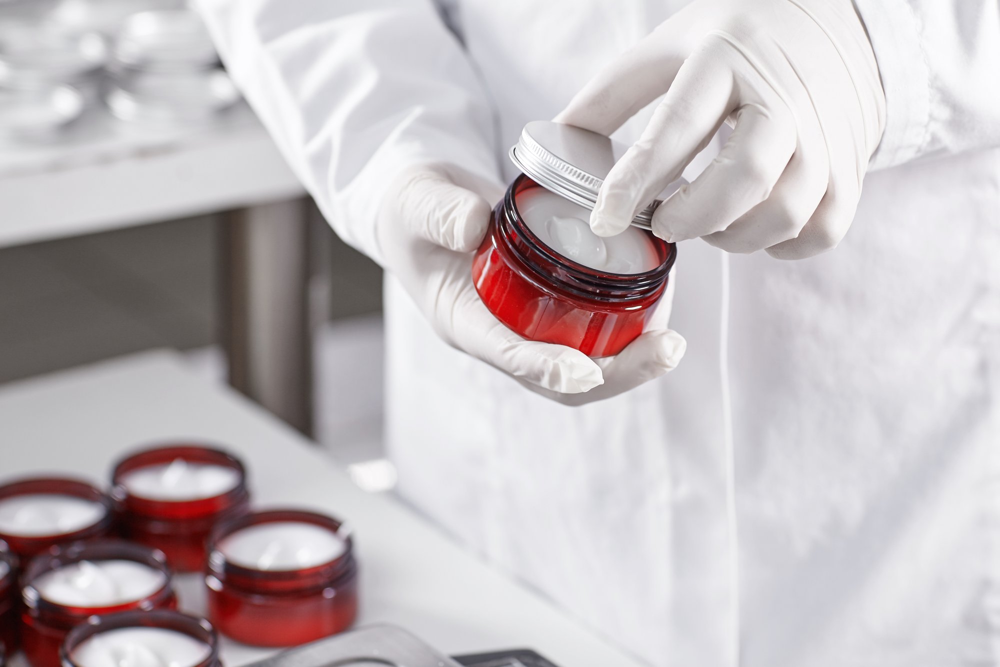 worker-filling-container-with-cream-cosmetic-factory worker-filling-container-with-cream-cosmetic-factory
